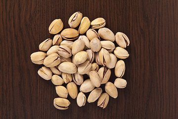 Image showing shelled pistachio on wooden