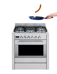 Image showing Hand and frying pan with gas-stove