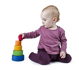 Image showing young child playing with colorful toy blocks