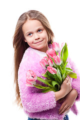 Image showing beautiful  little girl with bouquet of pink tulips isolated on white