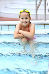 Image showing Child relaxing by swimming pool