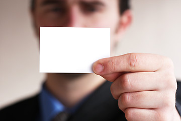 Image showing Businessman holding card