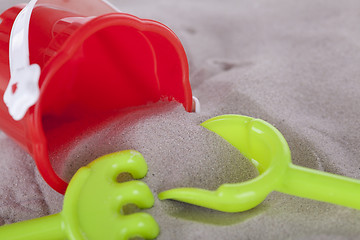 Image showing colorfull miniature toys in sand on beach