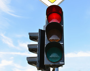 Image showing Red color traffic light blue sky in background 