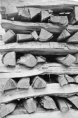 Image showing Background of dry chopped firewood logs stacked up on top of eac