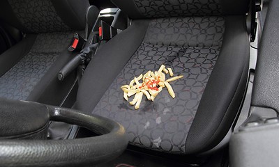 Image showing Messy French fries spilt on car seat