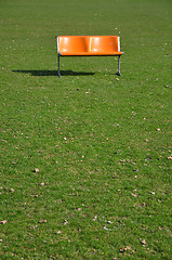 Image showing Orange bench on lawn