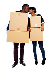 Image showing Couple holding cardboard boxes and kissing