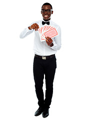 Image showing Portrait of a young man holding cards