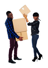 Image showing Smiling couple moving cardboard boxes