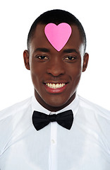 Image showing African man with pink paper heart on his forehead