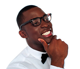 Image showing Smiling young man with hand on chin