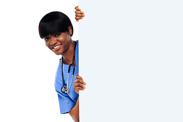 Image showing Female doctor holding long blank banner ad