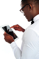 Image showing Rear-view of african holding a touch-pad device