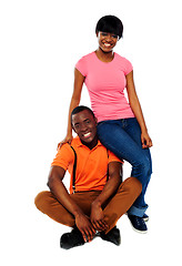 Image showing Woman in casuals sitting on mans shoulder