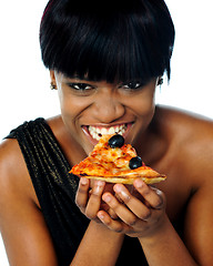 Image showing Woman enjoying pie of a pizza