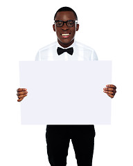 Image showing Smiling business representative holding whiteboard