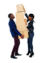 Image showing A young couple holds boxes in studio