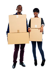 Image showing Attractive african couple holding cardboard boxes
