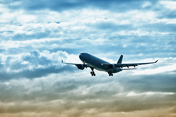 Image showing Airliner landing on evening sky