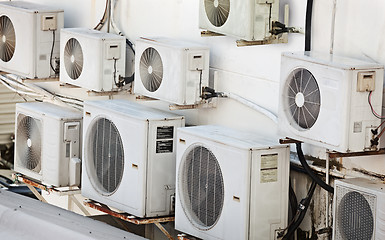 Image showing Many older air conditioners on the wall