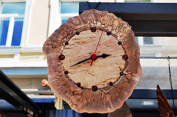 Image showing Handmade wooden clock decorated with amber stones 