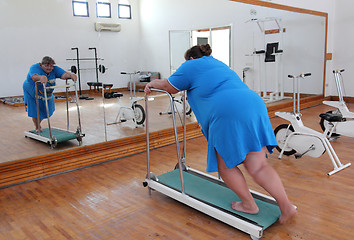 Image showing overweight woman running on trainer treadmill