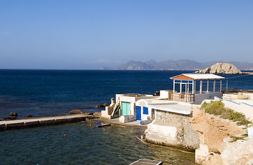 Image showing  houses built into rock cliffs on Mediterranean Sea Firopotamos 