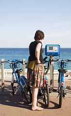 Image showing tourist looking at bicycle rental machine Nice France