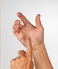 Image showing Male hand holding invisible smartphone