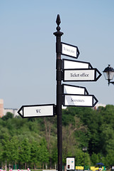 Image showing directional  arrow sign in a city park crossroad 