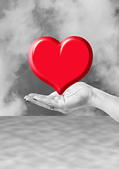 Image showing hand holding red heart, love or medical concept on black white background