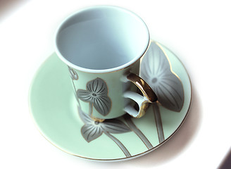 Image showing empty cup and saucer  with pattern  