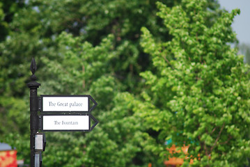 Image showing directional  arrow sign in a city park crossroad 