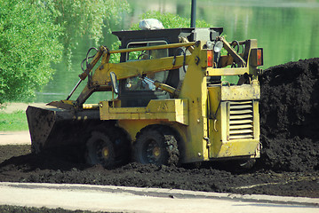 Image showing Mini excavator-grab working in city park  at the spring