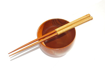 Image showing Chopsticks with wooden bowl isolated on white 