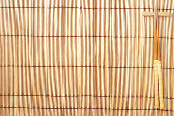 Image showing Chopsticks on brown bamboo matting background 