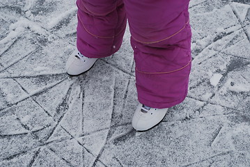 Image showing child  foots with skates on ice