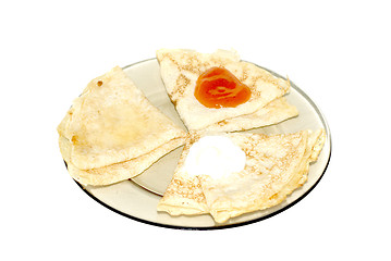 Image showing three pancakes  with jam, sour cream and honey 
