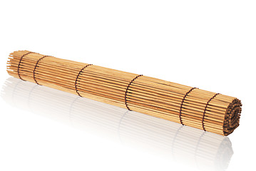 Image showing rolled bamboo mat on a white background                