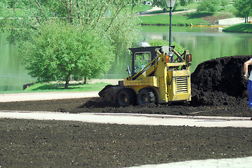 Image showing Mini excavator-grab working in city park  at the spring