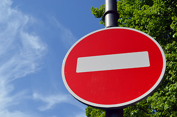 Image showing Limiting traffic sign white brick on red on sky 