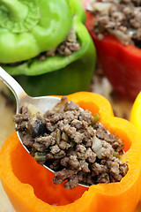 Image showing Stuffing colourful peppers vertical