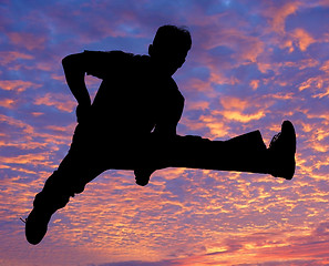 Image showing Boy jumping high in the air