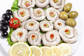 Image showing fish slices served with tomato and olives