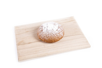 Image showing The fresh bun isolated on wooden plate