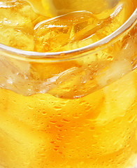 Image showing glass of orange juice with ice - macro