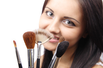 Image showing Beautiful young adult woman holds the make-up brushes