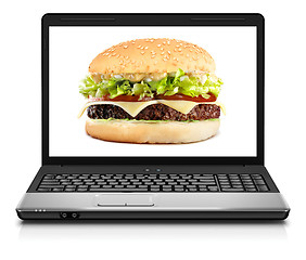 Image showing Laptop computer close-up with cheeseburger