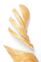 Image showing Fresh baguette, sliced, isolated on white background